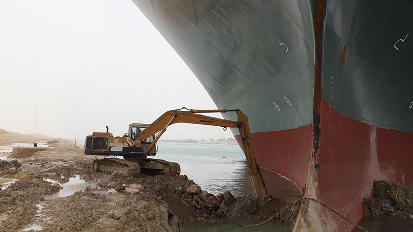REMOVES REFERENCE TO BACKHOE -  A work crew using excavating equipment tries to dig out the Ever Given, a Panama-flagged cargo ship, that is wedged across the Suez Canal and blocking traffic in the vital waterway. An operation is underway to try to w