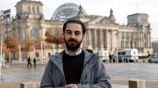Syrian migrant Tareq Alaows, who is running for the Greens party in the western state of North Rhine-Westphalia, for the September's federal general election poses during an interview with Reuters at the Reichstag building, the seat of the lower house of parliament Bundestag, in Berlin, Germany, February 3, 2021. Picture taken February 3, 2021.     REUTERS/Fabrizio Bensch