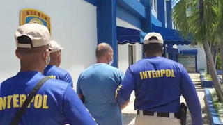 Interpol officers escort Marc Feren Claude Biart, 53, a mafia fugitive who was tracked down thanks to his tattoos visible in cooking videos he posted on YouTube, after arresting him in Boca Chica, Dominican Republic, in this still image taken from video filmed on March 24, 2021. Italian Police/Handout via REUTERS THIS IMAGE HAS BEEN SUPPLIED BY A THIRD PARTY. NO ARCHIVE. NO RESALES