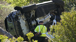 FILE - In this Feb. 23, 2021, file photo a vehicle rests on its side after a rollover accident involving golfer Tiger Woods, in Rancho Palos Verdes, Calif., a suburb of Los Angeles. The Los Angeles County sheriff says detectives have determined what caused Tiger Woods to crash his SUV last month in Southern California but would not release details on Wednesday, March 31, 2021, citing privacy concerns for the golf star. (AP Photo/Marcio Jose Sanchez, File)