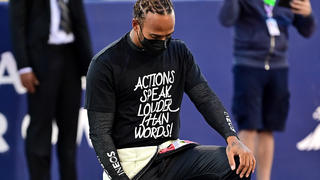 BAHRAIN, BAHRAIN - MARCH 28: Lewis Hamilton of Great Britain and Mercedes GP takes a knee on the grid in support of the Black Lives Matter movement prior to the F1 Grand Prix of Bahrain at Bahrain International Circuit on March 28, 2021 in Bahrain, Bahrain. (Photo by Andrej Isakovic -Pool/Getty Images)