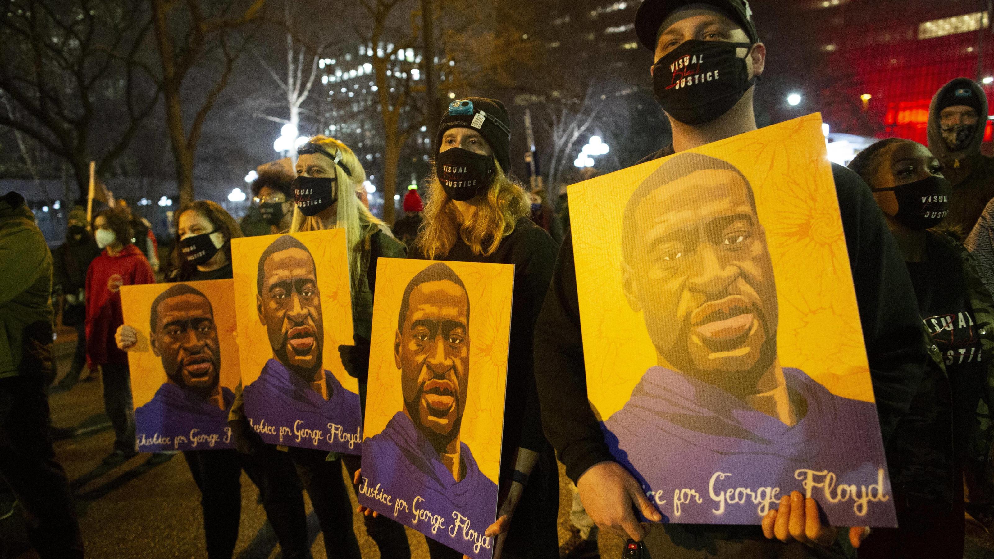April 9, 2021, Minneapolis, Minnesota, USA: April 9, 2021-Minneapolis, Minnesota, USA: Demonstrators hold portraits of GEORGE FLOYD at a march against police brutality amid DEREK CHAUVIN s trial in Downtown Minneapolis. Minneapolis USA - ZUMAp201 202