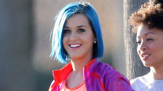 EXCLUSIVE: ** Premium Rates Apply **  Marriage-split Katy Perry looked in great shape in workout gear as she laughed off her divorce blues at a sporty photoshoot.The singer had not been seen in two weeks since husband Russell Brand filed for divorce - laying low at a luxury hotel and pulling out of a glitzy Hollywood awards show.But as she finally emerged back into the spotlight at a shoot for sportswear giant Adidas on January 12 the only thing blue about her was her newly-dyed hair.Although she was not wearing her wedding ring, Katy was sporting a simple band on her ring finger.Katy appeared in good spirits despite her marriage heartache as she smiled and joked with the photographers, models and crew on location by the beach in Santa Barbara, California.Posing in skimpy pink shorts and a running vest, she looked seemed to be having fun riding a BMX bike and jogging along a footpath.