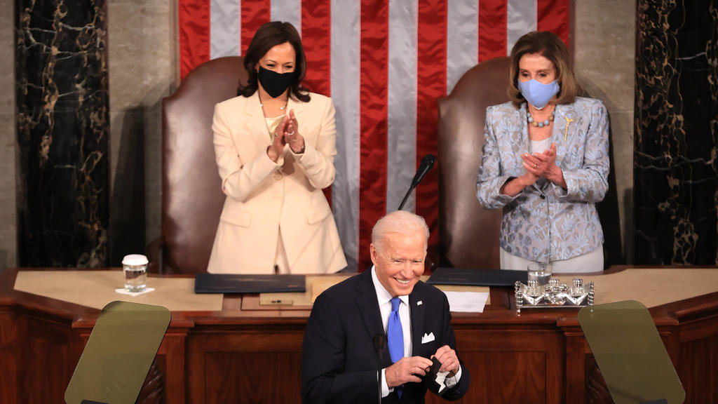 April 28, 2021, Washington, District of Columbia, USA: WASHINGTON, DC - APRIL 28: U.S. President Joe Biden addresses a joint session of congress as Vice President Kamala Harris L and Speaker of the House U.S. Rep. Nancy Pelosi D-CA R look on in the