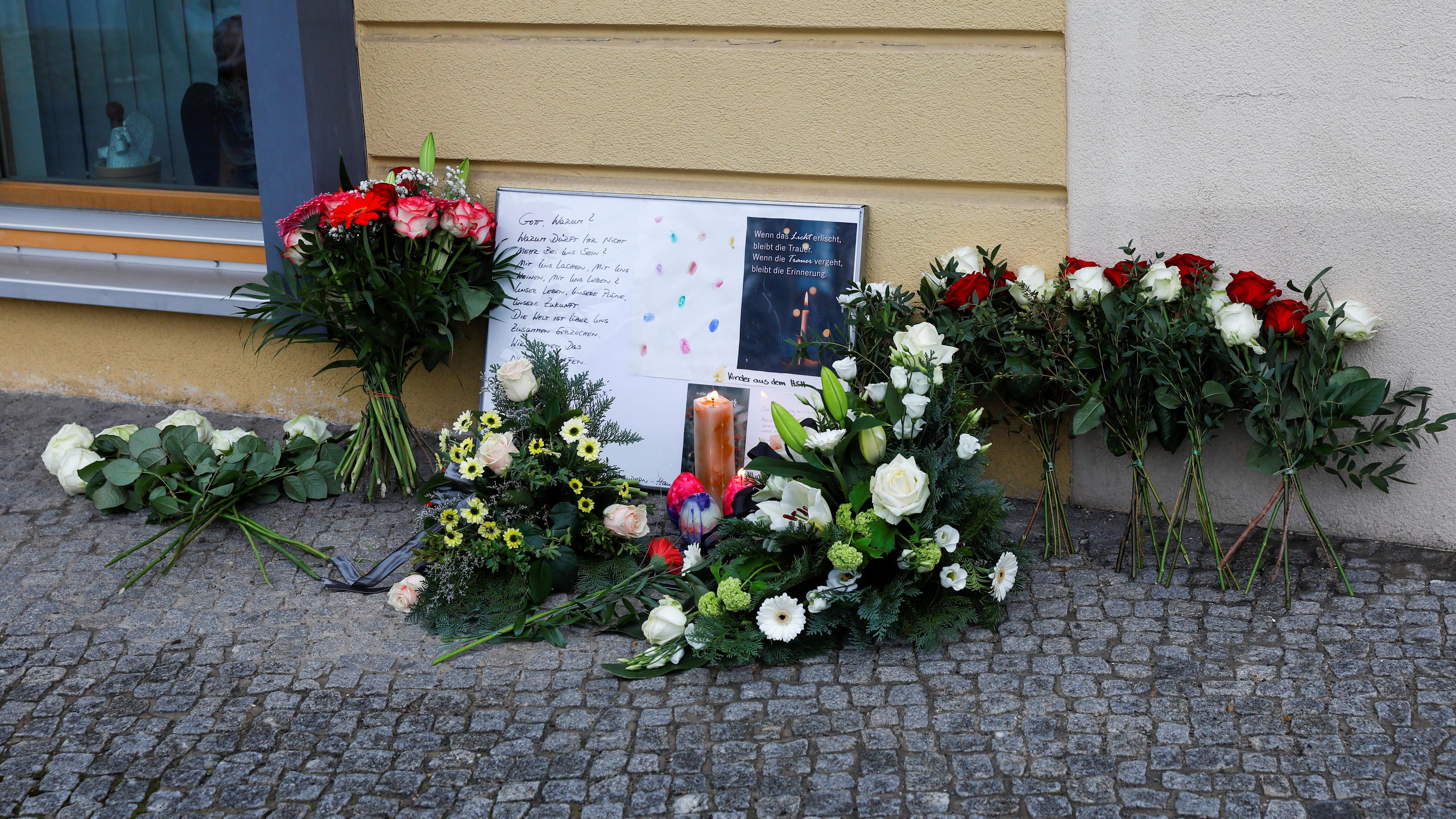 Messages and flowers are seen outside the Oberlin Clinic, following the arrest of a 51-year-old woman, after four people were found dead and another seriously injured at a hospital, in Potsdam, Germany, April 29, 2021. REUTERS/Michele Tantussi
