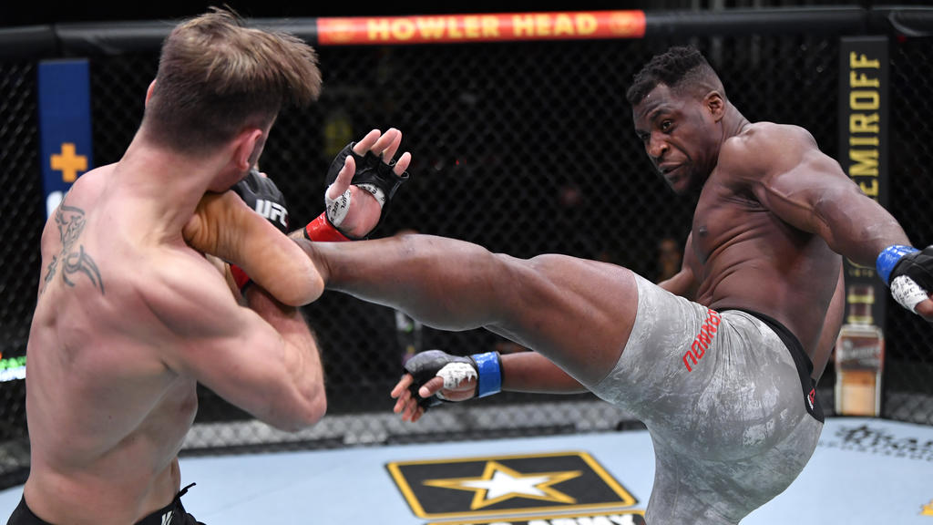 Mar 27, 2021; Las Vegas, NV, USA; Francis Ngannou of Cameroon kicks Stipe Miocic in their UFC heavyweight championship fight during the UFC 260 event at UFC APEX on March 27, 2021 in Las Vegas, Nevada. Mandatory Credit: Jeff Bottari/Handout Photo v