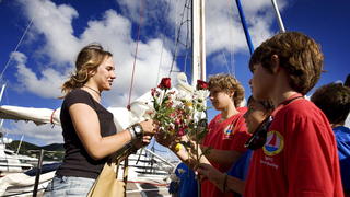 Laura Dekker (L) is welcomed with flowers upon arrival in the port of St. Martin after her solo trip around the world, Sint Maarten, The Netherlands, 2012. The 16-year-old Dutch girl left a year ago from St. Maarten and is the youngest solo sailor who has sailed around the world. EPA/JERRY LAMPEN  +++(c) dpa - Bildfunk+++