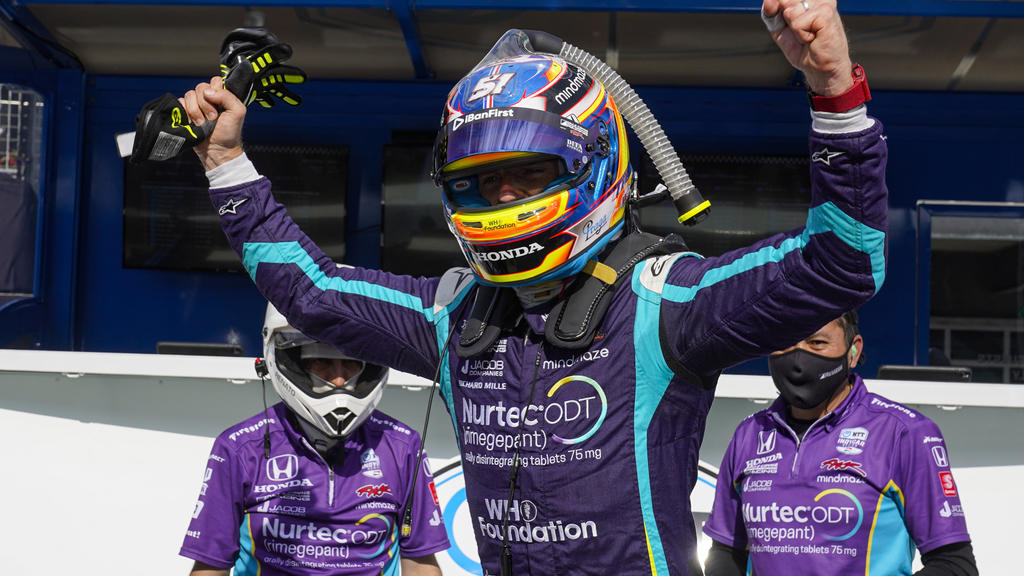 Romain Grosjean, of Switzerland, celebrates after winning the pole during qualifications for the IndyCar auto race at Indianapolis Motor Speedway in Indianapolis, Friday, May 14, 2021. (AP Photo/Michael Conroy)