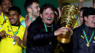 BERLIN, GERMANY - MAY 13: Head coach Edin Terzic (C) of Borussia Dortmund celebrates with the trophy after winning the DFB Cup final match between RB Leipzig and Borussia Dortmund at Olympic Stadium on May 13, 2021 in Berlin, Germany. Sporting stadiums around Germany remain under strict restrictions due to the Coronavirus Pandemic as Government social distancing laws prohibit fans inside venues resulting in games being played behind closed doors. (Photo by Martin Rose/Getty Images)