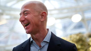 FILE PHOTO: Amazon founder and CEO Jeff Bezos laughs as he talks to the media while touring the new Amazon Spheres during the grand opening at Amazon's Seattle headquarters in Seattle, Washington, U.S., January 29, 2018.   REUTERS/Lindsey Wasson/File Photo