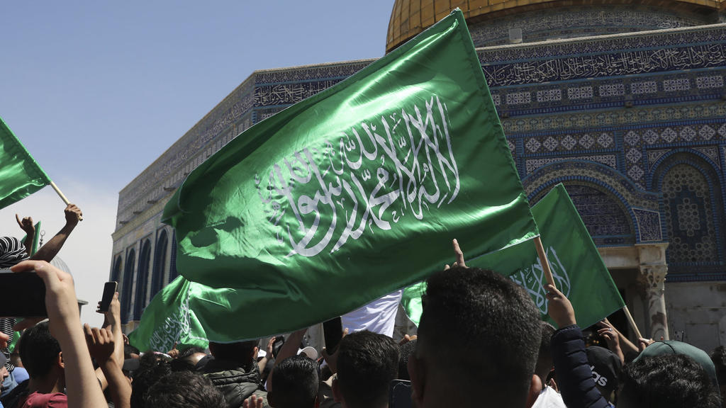 Worshippers wave Hamas flags during a protest against the likely evictions of Palestinian families from the homes, after the last Friday prayers of the Muslim holy month of Ramadan at the Dome of the Rock Mosque in the Al Aqsa Mosque compound in the