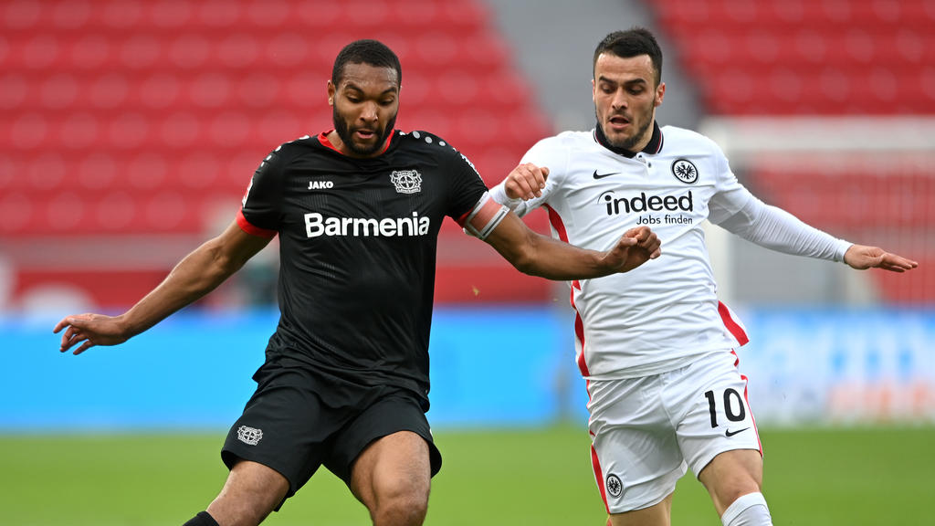 LEVERKUSEN, GERMANY - APRIL 24: Jonathan Tah of Bayer 04 Leverkusen battles for possession with Filip Kostic of Eintracht Frankfurt during the Bundesliga match between Bayer 04 Leverkusen and Eintracht Frankfurt at BayArena on April 24, 2021 in Leve