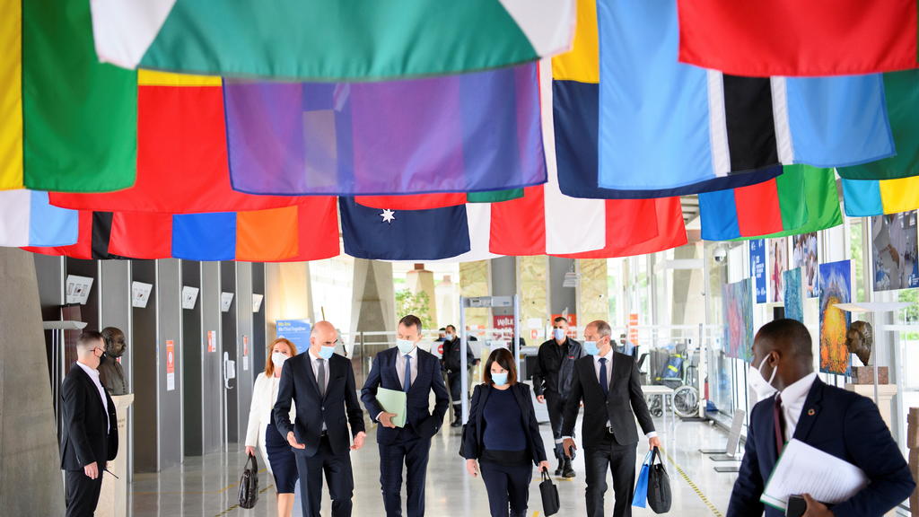 Swiss Interior and Health Minister Alain Berset walks with Swiss ambassador and Permanent Representative of Switzerland to the United Nations, Juerg Lauber, and Swiss Ambassador Nora Kronig Romero, Head of International Affairs Division and Vice Dire