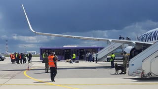 Airport personnel and security forces are seen on the tarmac in front of a Ryanair flight which was forced to land in Minsk, Belarus, May 23, 2021. Picture taken May 23, 2021. Handout via REUTERS ATTENTION EDITORS - THIS PICTURE WAS PROVIDED BY A THIRD PARTY.