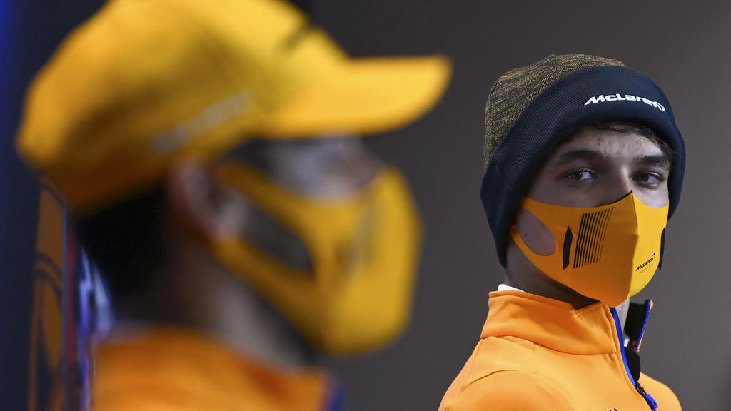 Mclaren driver Lando Norris of Britain looks at teammate Mclaren driver Daniel Ricciardo of Australia, left, during a news conference ahead of the Portugal Formula One Grand Prix at the Algarve International Circuit near Portimao, Portugal, Thursday,