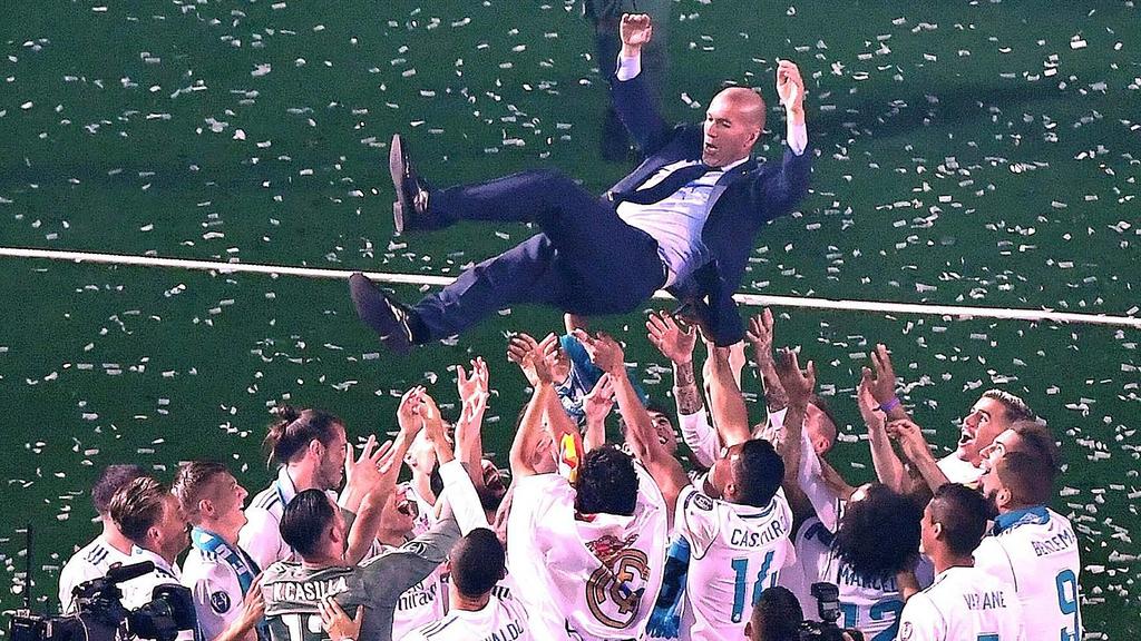 (180528) -- MADRID, May 28, 2018 -- Real Madrid s head coach Zidane is thrown into the air by players during the celebration at Santiago Bernabeu Stadium in Madrid, Spain, on May 27, 2018. Real Madrid claimed the title of UEFA champions league in Kie
