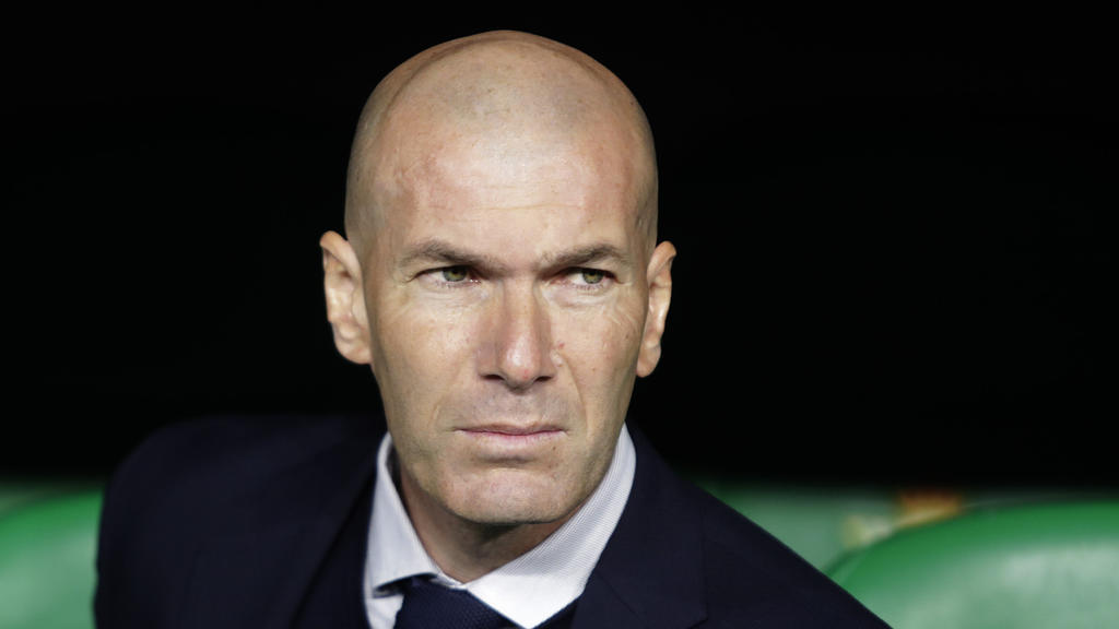 FILE - In this In this file photo dated March 8, 2020, Real Madrid's head coach Zinedine Zidane sits at the bench during La Liga soccer match in Seville, Spain. Zinedine Zidane is again stepping down as Real Madrid coach. The club says the Frenchman