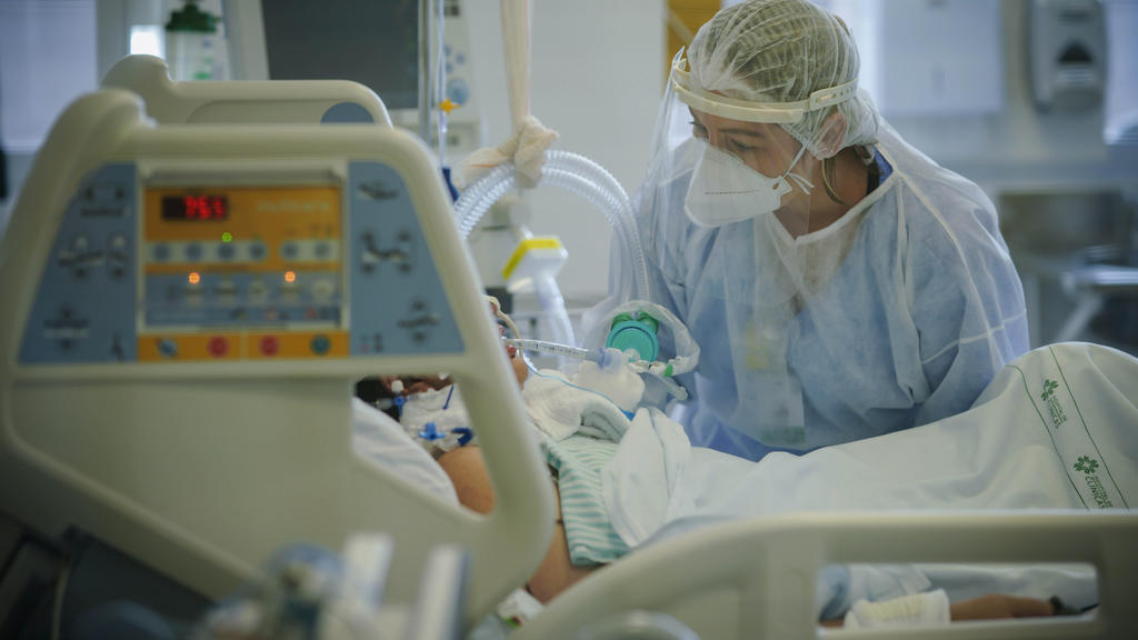 ARCHIV - 19.03.2021, Brasilien, Porto Alegre: Ein medizinische Mitarbeiterin behandelt im Krankenhaus «Hospital das Clinicas» einen Covid-19-Patienten auf der Intensivstation. (zu dpa «Studie: Einsatz von Antibiotika bei Covid-19-Patienten oft unnöti