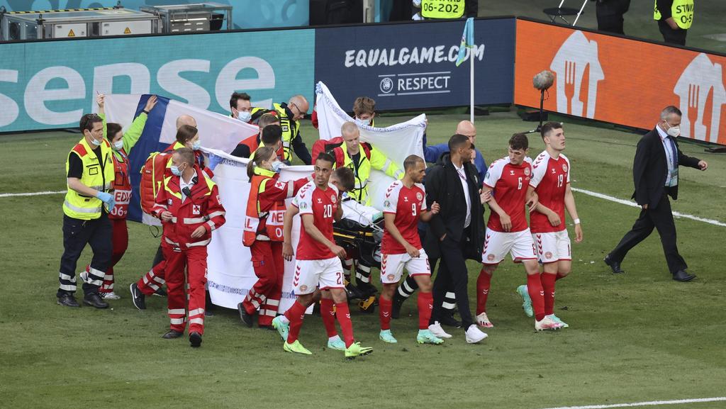 Paramedics using a stretcher to take out of the pitch Denmark's Christian Eriksen after he collapsed during the Euro 2020 soccer championship group B match between Denmark and Finland at Parken stadium in Copenhagen, Denmark, Saturday, June 12, 2021.