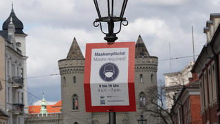 ARCHIV - 14.04.2021, Brandenburg, Potsdam: «Maskenpflicht» steht auf einem Schild in der Potsdamer Innenstadt. Brandenburgs Landesregierung beschloss angesichts sinkender Infektionszahlen am Dienstag weitreichende Lockerungen: Die Maskenpflicht etwa im Freien fällt weg.  (zu dpa: «Brandenburg hebt Kontaktbeschränkungen auf und öffnet Clubs») Foto: Paul Zinken/dpa-Zentralbild/dpa - ACHTUNG: Verwendung nur im vollen Format +++ dpa-Bildfunk +++