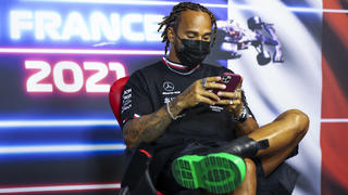 Mercedes driver Lewis Hamilton of Britain checks his smartphone as he attends a press conference ahead of the French Formula One Grand Prix at the Paul Ricard racetrack in Le Castellet, southern France, Thursday, June 17, 2021. The French Grand Prix will be held on Sunday. (Antonin Vincent, Pool via AP)