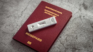  Bavaria, Germany - 08 april 2021: german passport with a negative coronavirus covid-19 self rapid test. travel concept during the covid-19 pandemic. german certificate of health. Reisepass