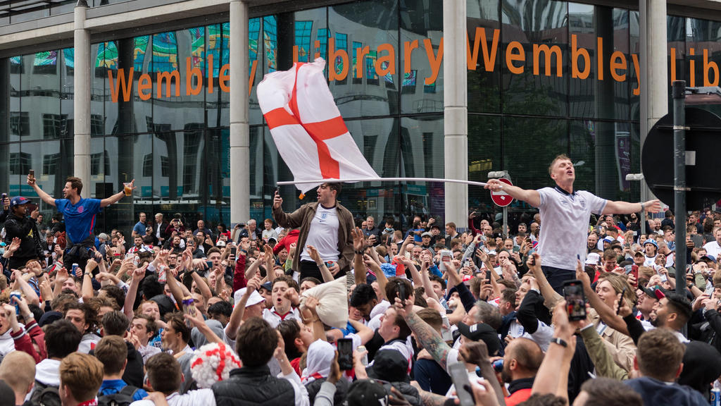 Football Fans Arrive At Wembley Stadium For England Vs Germany Euro 2020 Match In London LONDON, UNITED KINGDOM - JUNE 29, 2021: England football fans celebrate outside Wembley Stadium ahead of England match against Germany in the Euro 2020 Champion