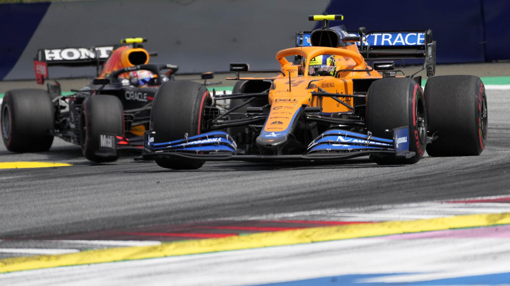 Mclaren driver Lando Norris of Britain leads ahead of Red Bull driver Sergio Perez of Mexiconduring the Styrian Formula One Grand Prix at the Red Bull Ring racetrack in Spielberg, Austria, Sunday, June 27, 2021. (AP Photo/Darko Vojinovic)