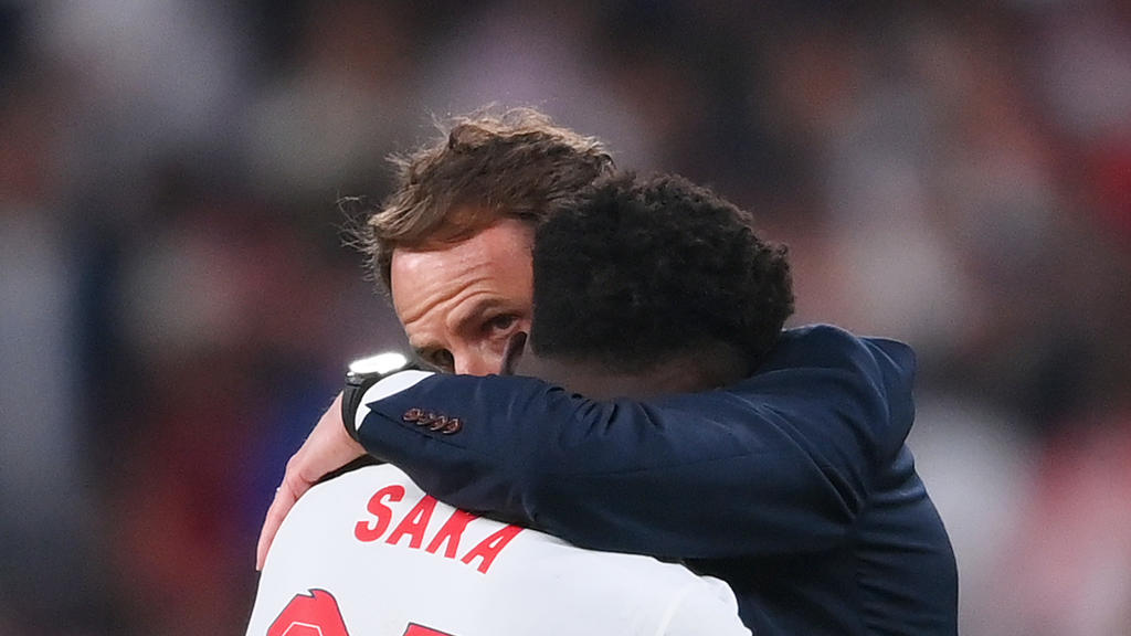LONDON, ENGLAND - JULY 11: Bukayo Saka of England is consoled by Gareth Southgate, Head Coach of England following defeat in the UEFA Euro 2020 Championship Final between Italy and England at Wembley Stadium on July 11, 2021 in London, England. (Phot
