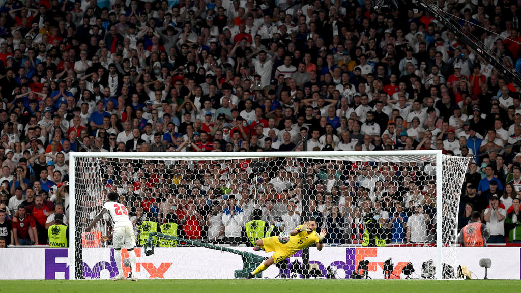 LONDON, ENGLAND - JULY 11: Bukayo Saka of England misses his team's fifth penalty in a penalty shoot out which is saved by Gianluigi Donnarumma of Italy during the penalty shoot out in the UEFA Euro 2020 Championship Final between Italy and England a