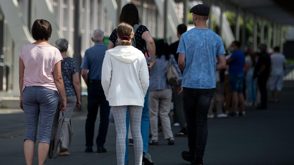 18.07.2021, Niedersachsen, Hannover: Impflinge stehen am Eingang vom Impfzentrum auf dem Messegelände in einer Schlange. Bei einer landesweiten Impfaktion für Kinder und Jugendliche wurden rund 27 000 Impfdosen gegen das Coronavirus für den Aktionsta