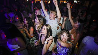 People react on the dance floor shortly after the reopening, at The Piano Works in Farringdon, in London, Monday, July 19, 2021. Thousands of young people plan to dance the night away at 'Freedom Day' parties after midnight Sunday, when almost all coronavirus restrictions in England are to be scrapped. Nightclubs, which have been shuttered since March 2020, can finally reopen. (AP Photo/Alberto Pezzali)