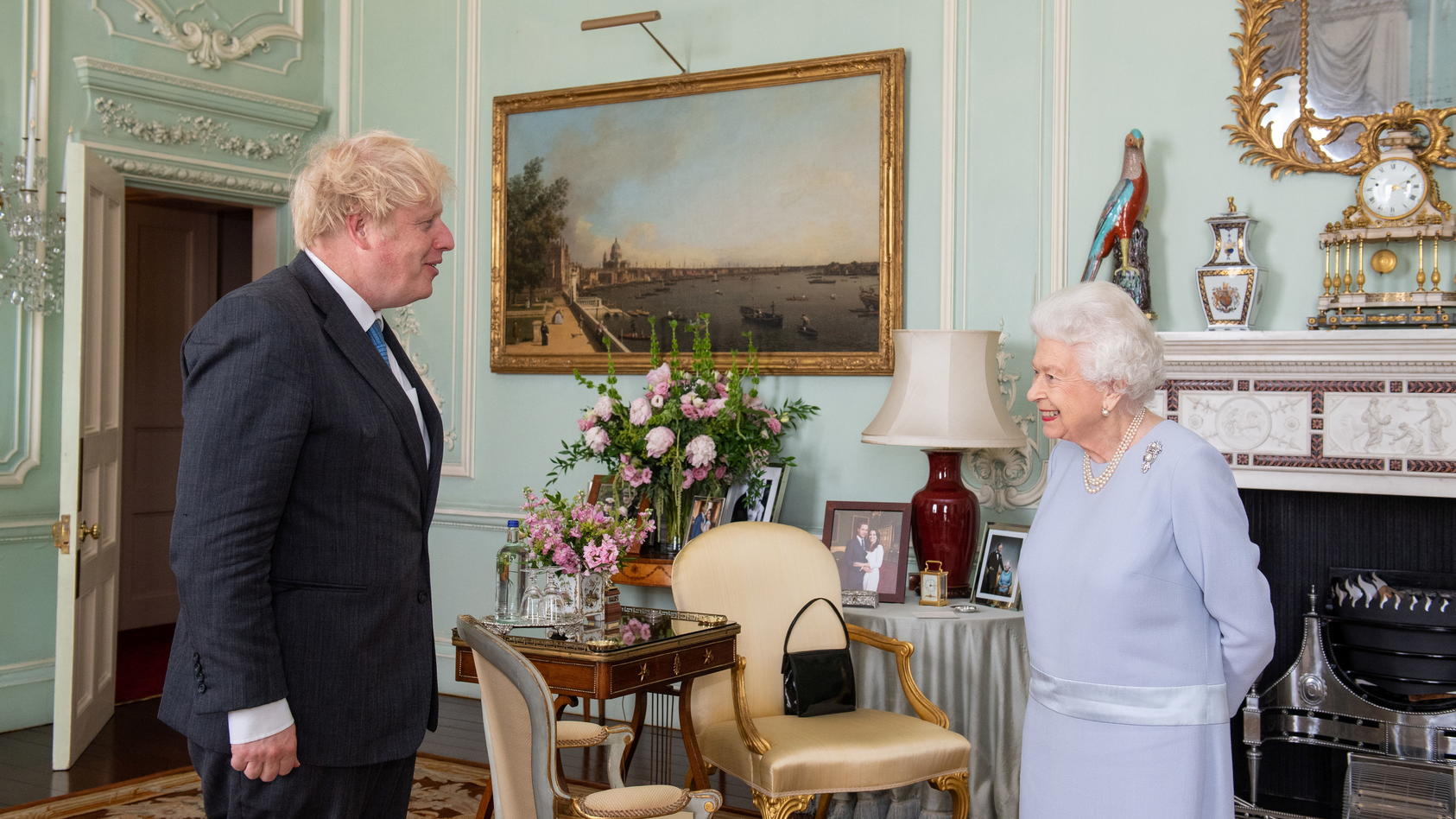 Britain's Queen Elizabeth II greets Prime Minister Boris Johnson at the first in-person weekly audience with the Prime Minister since the start of the coronavirus pandemic, at Buckingham Palace in London, Briain June 23, 2021. Dominic Lipinski/Pool v