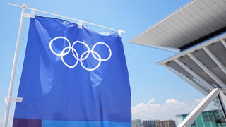 19.07.2021, Japan, Tokio: Eine Fahne mit den Olympischen Ringen hängt vor einem Gebäude. Die Olympischen Spiele 2020 Tokio finden vom 23.07.2021 bis zum 08.08.2021 statt. Foto: Michael Kappeler/dpa +++ dpa-Bildfunk +++