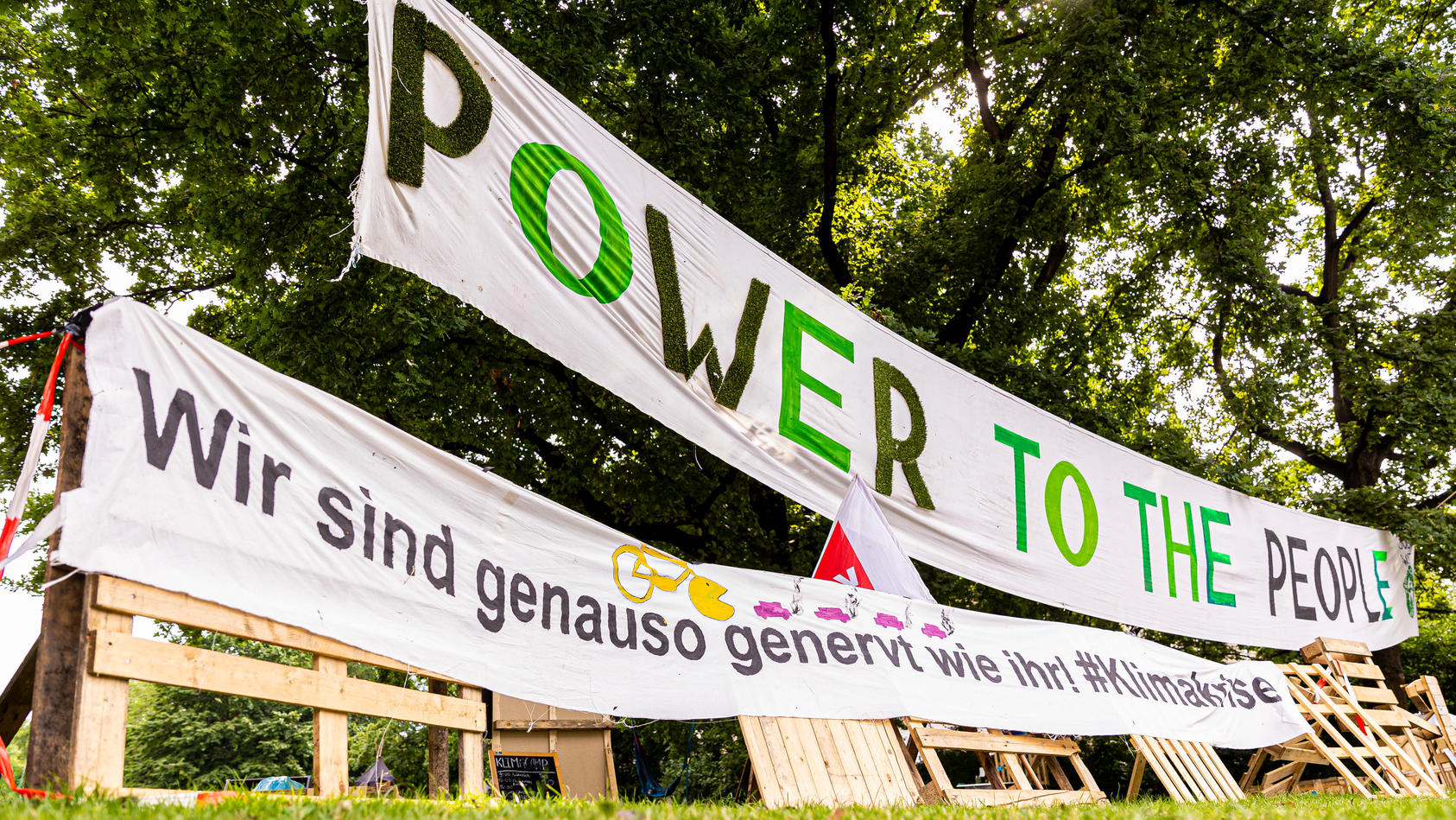 Mit großen Bannern und Plakaten machen die Klimaschützer vor dem Rathaus Hannover auf sich aufmerksam.