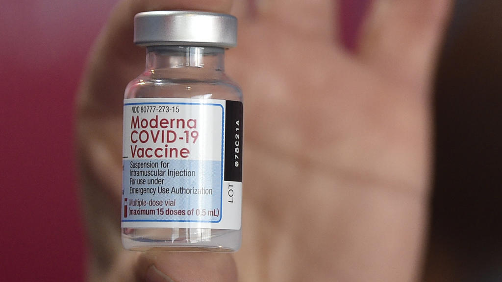 A health worker shows a vial of the Moderna vaccine for COVID-19, donated by the US government, at a health center in Quilmes, Argentina, Tuesday, Aug. 3, 2021. Argentina is vaccinating youths with pre-existing conditions, between ages 12 and 17. â€‹
