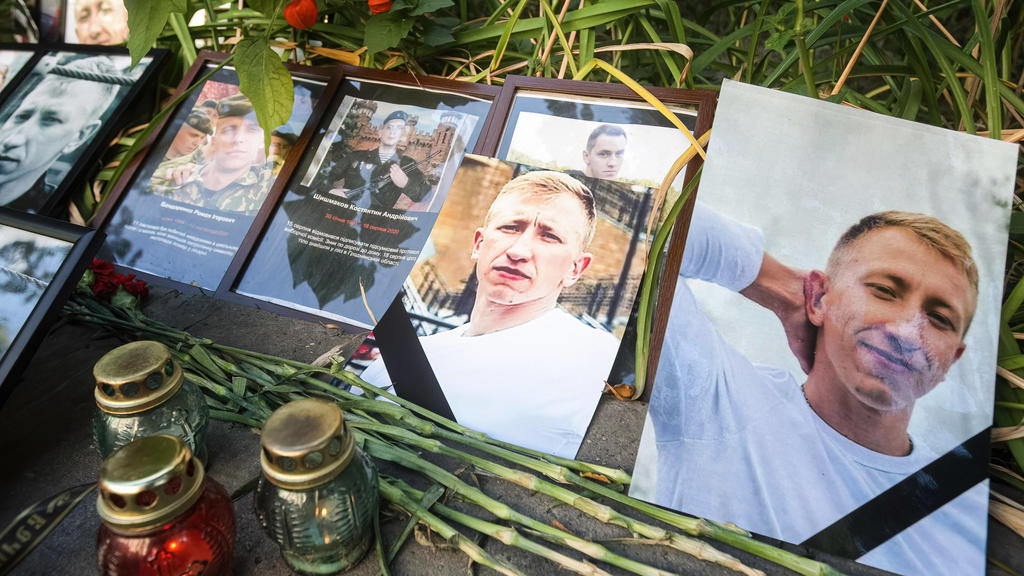 August 3, 2021, Kiev, Ukraine: Flowers and candles are left with photos of Belarusian opposition activist and Head of the Belarusian House in Ukraine Vitaly Shishov outside the Belarus Embassy during a protest in his memory..Belarusian activist Vita