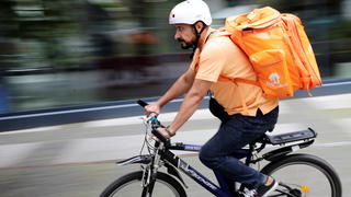 Former Afghan Communication Minister Sayed Sadaat rides a bicycle for his food delivery service job with Lieferando in Leipzig, Germany, August 26, 2021. REUTERS/Hannibal Hanschke