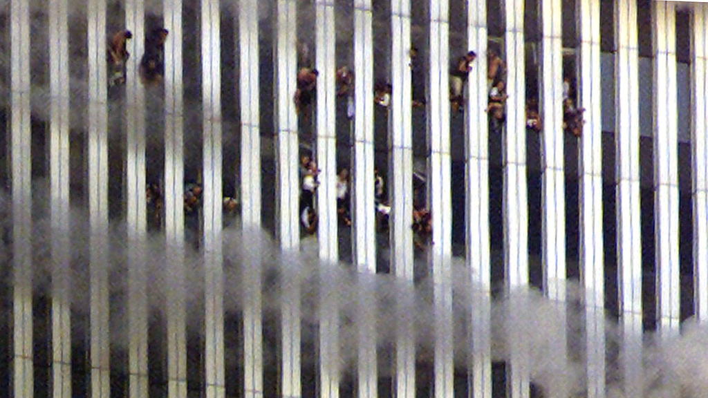FILE PHOTO: People look out of the burning North tower of the World Trade Center in New York City, New York, U.S. September 11, 2001. REUTERS/Jeff Christensen/File Photo SEARCH 20TH ANNIVERSARY OF THE SEPTEMBER 11 ATTACKS FOR THE PHOTOS