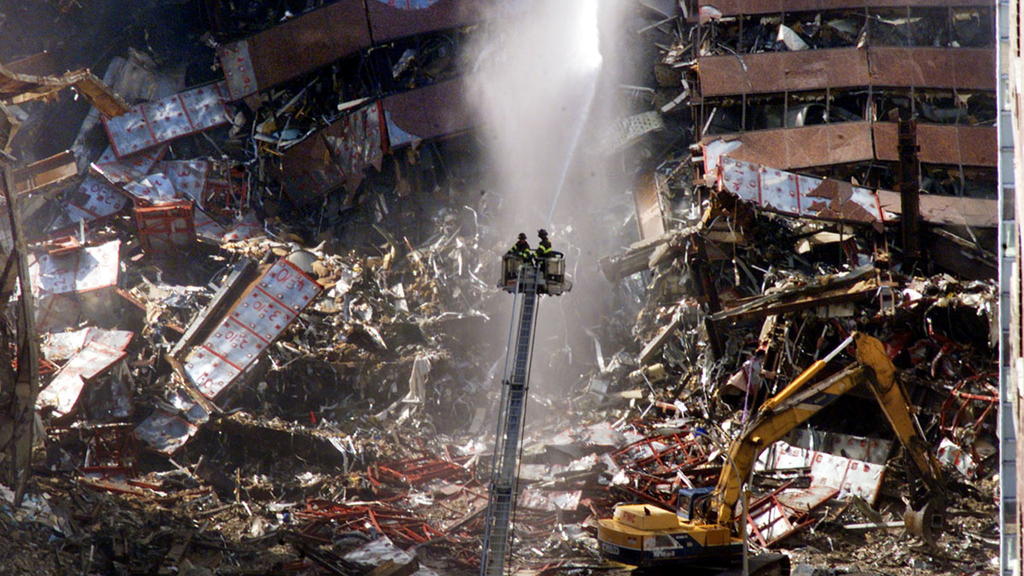 FILE PHOTO: New York City firefighters pour water on the wreckage of 7 World Trade Center in New York, U.S., early September 12, 2001. REUTERS/Mike Segar/File Photo SEARCH 20TH ANNIVERSARY OF THE SEPTEMBER 11 ATTACKS FOR THE PHOTOS
