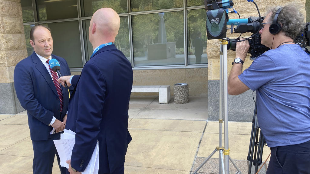 A reporter interviews acting U.S. Attorney Jonathan Lenzner outside the federal courthouse in Greenbelt, Md., on Wednesday, Sept. 15, 2021, after a judge sentenced Eric Eoin Marques to 27 years in prison. U.S. authorities have said Marques, 36, was t