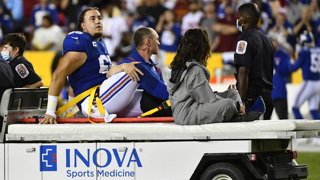 Sep 16, 2021; Landover, Maryland, USA; New York Giants center Nick Gates (65) reacts after suffering an apparent leg injury against the Washington Football Team during the first half at FedExField. Mandatory Credit: Brad Mills-USA TODAY Sports