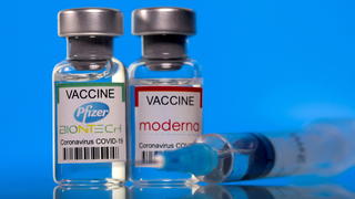 FILE PHOTO: Vials with Pfizer-BioNTech and Moderna coronavirus disease (COVID-19) vaccine labels are seen in this illustration picture taken March 19, 2021. REUTERS/Dado Ruvic/Illustration//File Photo
