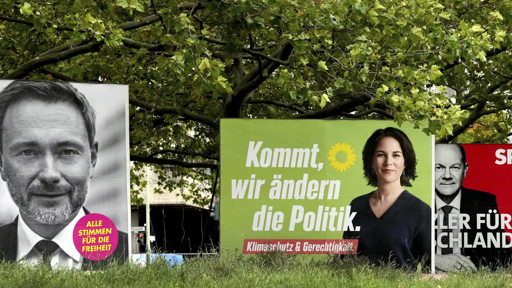 Four elections posters show top candidate of the German Liberals Christian Lindner, left, top candidate for chancellor of the Greens Annalena Baerbock, second left, Social Democratic top candidate for chancellor Olaf Scholz, second right, and Christi