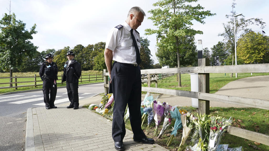 Chief Superintendent Trevor Lawry stands by the floral tributes at Cator Park in Kidbrooke, near to the area where the body of Sabina Nessa was found, in London, Thursday, Sept. 23, 2021. British police investigating the killing of a 28-year-old woma