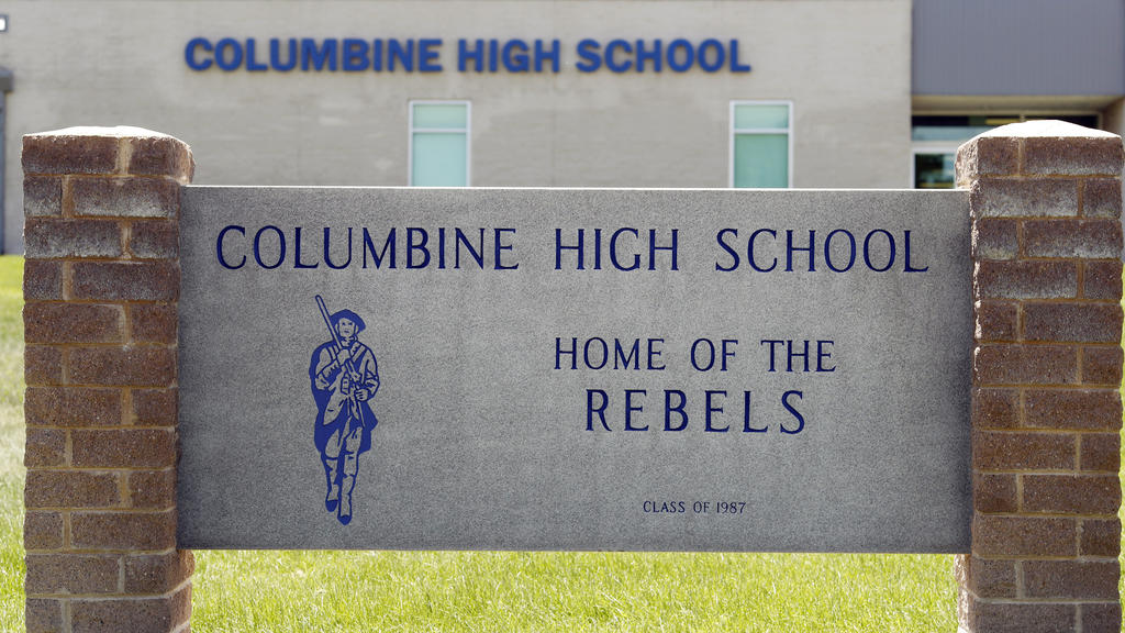 FILE - This June 13, 2019, file photo shows signs outside Columbine High School in Littleton, Colo. The Jefferson County School District has abandoned a proposal to demolish Columbine and replace it after a community survey showed strong opposition t