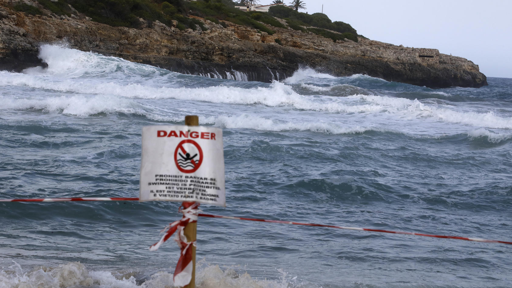 02.09.2021, Spanien, Manacor: Ein Schild verbietet das Schwimmen am Strand von Cala Mendia in Manacor auf Mallorca. Zwei junge Urlauberinnen aus Nordrhein-Westfalen sind hier im Meer vor Mallorca ertrunken. Die beiden Schwestern waren nach ersten Erk