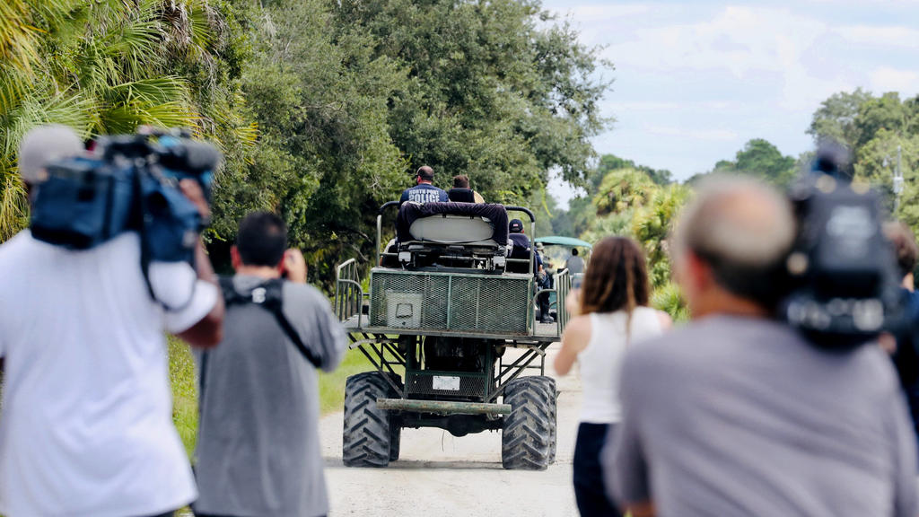 Members of the media film law enforcement as they drive swamp buggies down a dirt road on the Southside of the Carlton Reserve, while searching for any signs of Brian Laundrie, Tuesday, Sept. 21, 2021, in Venice, Fla. Search teams found nothing of no