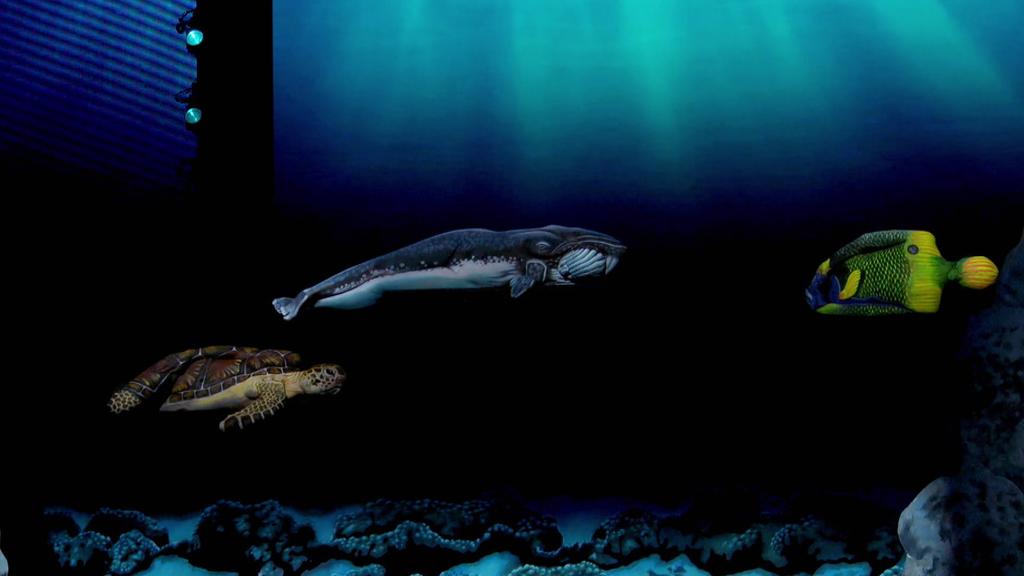 Durch Bodypainting wurden drei Frauen in eine Schildkröte, einen Wal und einen Fisch verwandelt.
