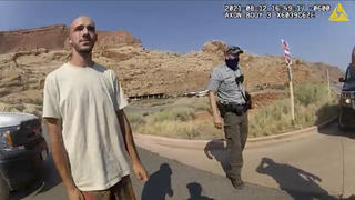 FILE - This Aug. 12, 2021 file photo from video provided by The Moab Police Department shows Brian Laundrie talking to a police officer after police pulled over the van he was traveling in with his girlfriend, Gabrielle "Gabby" Petito, near the entrance to Arches National Park. Laundrie, the boyfriend of Gabby Petito, whose body was found at a national park in Wyoming after a cross-country trip with him, has been charged with unauthorized use of a debit card as searchers continue looking for him in Florida swampland, federal authorities announced Thursday, Sept. 23, 2021. (The Moab Police Department via AP, File)